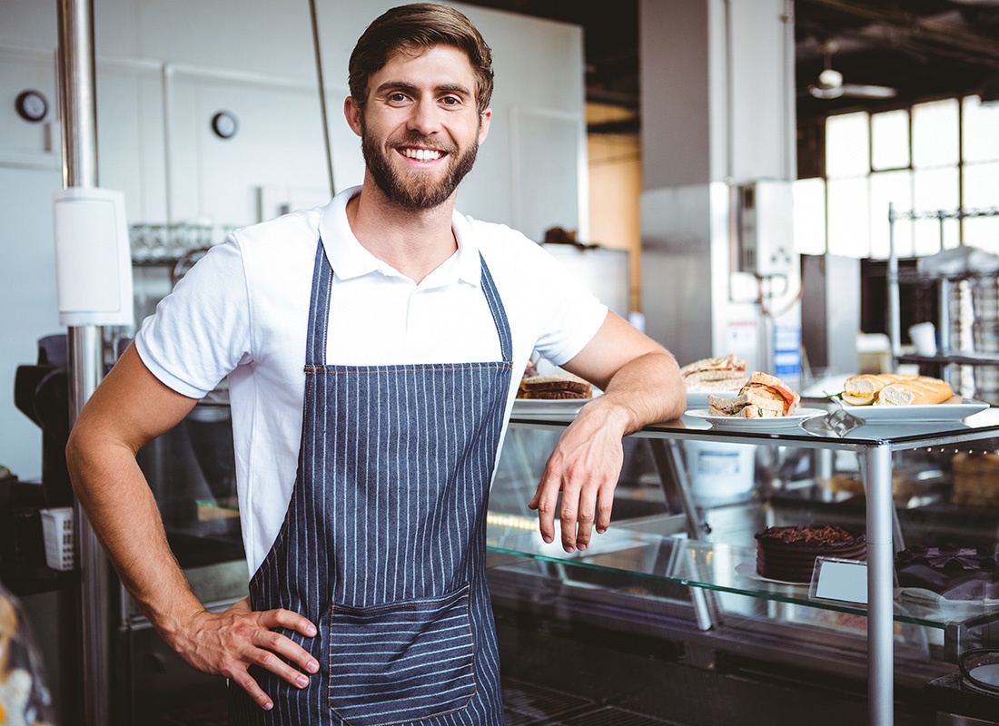 Business Insurance - Working Standing by a Counter at a Sandwich Shop